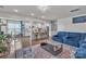 Open-concept living area with a blue sectional, modern kitchen, and hardwood floors at 1115 Macallum Nw Dr, Concord, NC 28027