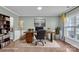 Inviting home office featuring hardwood floors, wainscoting, a large desk, and ample natural light at 1115 Macallum Nw Dr, Concord, NC 28027