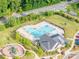 Aerial view of community pool and clubhouse nestled amongst lush landscaping and mature trees at 1115 Macallum Nw Dr, Concord, NC 28027