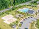 Aerial view of recreational area offering a pool, volleyball court, and a playground in a green space at 1115 Macallum Nw Dr, Concord, NC 28027