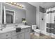 Bathroom area features a white vanity and a shower with striped curtain at 1124 St. Charles Ct # 3, Newton, NC 28658