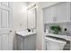 This is a bathroom with white cabinets, a sink, and a decorative plant at 1124 St. Charles Ct # 3, Newton, NC 28658