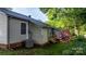 Home exterior showcasing neutral siding, brick foundation, and a decorative pink metal flower at 1124 St. Charles Ct # 3, Newton, NC 28658