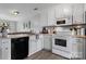 This kitchen features white cabinets, hardwood floors, and modern appliances at 1124 St. Charles Ct # 3, Newton, NC 28658