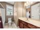 Neutral toned bathroom features a window for natural light and a vanity with marble countertop at 1152 Mckee Farm Ln, Belmont, NC 28012
