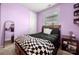 This bedroom features lavender walls, a black bedspread and a bed with drawer storage at 1152 Mckee Farm Ln, Belmont, NC 28012
