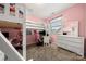 Pink bedroom features a white loft bed and a matching white dresser and vanity at 1152 Mckee Farm Ln, Belmont, NC 28012