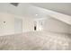 A view of the bonus room shows neutral carpeting, a light-toned paint color and a window to the outdoors at 1152 Mckee Farm Ln, Belmont, NC 28012