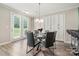Bright dining area with access to the yard, modern table, and built in cabinets at 1152 Mckee Farm Ln, Belmont, NC 28012