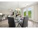 Bright dining area connected to the living room, with a modern table and access to the yard at 1152 Mckee Farm Ln, Belmont, NC 28012
