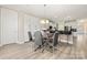 Bright dining area with wood floors, modern table, and built in cabinets at 1152 Mckee Farm Ln, Belmont, NC 28012