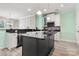 Bright kitchen featuring a black island, modern appliances, and sleek countertops at 1152 Mckee Farm Ln, Belmont, NC 28012