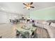 Open-concept living room featuring hardwood floors, modern furniture, and a ceiling fan for a spacious and inviting atmosphere at 1152 Mckee Farm Ln, Belmont, NC 28012