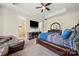 Cozy main bedroom with tray ceilings, a ceiling fan, and an ensuite bathroom at 1152 Mckee Farm Ln, Belmont, NC 28012