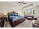 Spacious main bedroom with large windows, providing ample natural light, and modern furniture at 1152 Mckee Farm Ln, Belmont, NC 28012