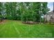 Spacious backyard featuring a lush lawn and mature trees for privacy at 1233 Ladera Dr, Waxhaw, NC 28173