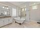 Elegant bathroom featuring a freestanding tub, a glass-enclosed shower, and dual vanities at 1233 Ladera Dr, Waxhaw, NC 28173