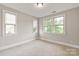 Bright bedroom features neutral carpet and three windows at 1233 Ladera Dr, Waxhaw, NC 28173