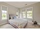 Well-lit bedroom features soft colored walls and carpet, as well as large windows at 1233 Ladera Dr, Waxhaw, NC 28173