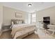 Cozy bedroom features neutral carpet, a ceiling fan, and a large bed at 1233 Ladera Dr, Waxhaw, NC 28173