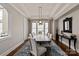 Elegant dining room with tray ceiling, dark wood floors, and a large window at 1233 Ladera Dr, Waxhaw, NC 28173