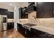 Stunning kitchen featuring dark wood cabinetry, stainless steel appliances, and a granite countertop with a gas cooktop at 1233 Ladera Dr, Waxhaw, NC 28173
