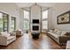 Bright living room with high ceilings, fireplace, hardwood floors, and large windows at 1233 Ladera Dr, Waxhaw, NC 28173