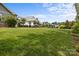 Large backyard featuring a green lawn and dark metal fence showcasing the exterior landscape at 124 Slocumb Ln, Mooresville, NC 28117