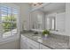 Bathroom vanity features granite counters, white cabinets, and natural light at 124 Slocumb Ln, Mooresville, NC 28117