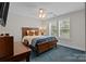 Bedroom with blue carpet and ceiling fan plus large window with wood blinds at 124 Slocumb Ln, Mooresville, NC 28117