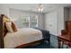 Bedroom with full-size bed, ceiling fan and window with white shutter blinds at 124 Slocumb Ln, Mooresville, NC 28117