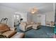 Comfortable bonus room features a cozy sitting area, exercise equipment, and a ceiling fan at 124 Slocumb Ln, Mooresville, NC 28117