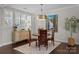 Cozy dining room featuring a round wood table, stylish chandelier, and plantation shutters at 124 Slocumb Ln, Mooresville, NC 28117