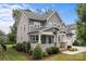 Stylish two-story home with a welcoming front porch and well-manicured landscaping at 124 Slocumb Ln, Mooresville, NC 28117