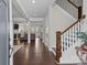 Inviting foyer featuring hardwood floors, elegant staircase, and an open view to the living area at 124 Slocumb Ln, Mooresville, NC 28117