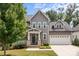 Inviting two-story home featuring a covered front porch and well-maintained lawn at 124 Slocumb Ln, Mooresville, NC 28117