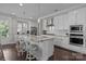 Modern kitchen featuring white cabinets, granite countertops, and stainless steel appliances at 124 Slocumb Ln, Mooresville, NC 28117