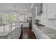 Bright kitchen with white cabinets, granite counters, and stainless steel appliances at 124 Slocumb Ln, Mooresville, NC 28117