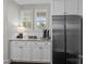 Bright kitchen featuring granite countertops, white cabinets, and stainless steel refrigerator at 124 Slocumb Ln, Mooresville, NC 28117