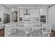 Modern kitchen featuring white cabinets, granite countertops, stainless steel appliances, and a large island at 124 Slocumb Ln, Mooresville, NC 28117