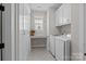Functional laundry room featuring built-in cabinets, counter space, and modern washer/dryer at 124 Slocumb Ln, Mooresville, NC 28117