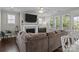 Bright living room with a fireplace, large windows, and comfortable seating area at 124 Slocumb Ln, Mooresville, NC 28117