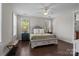 Inviting main bedroom with a ceiling fan, hardwood floors, and natural light from large windows at 124 Slocumb Ln, Mooresville, NC 28117