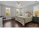 Serene main bedroom featuring hardwood floors, large windows, and a comfortable seating area at 124 Slocumb Ln, Mooresville, NC 28117