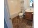 This bathroom includes a shower-tub combo and a wood vanity at 12450 Stone Garden Dr, Huntersville, NC 28078