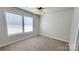 This bedroom includes carpeted floors, a ceiling fan, and dual windows at 12450 Stone Garden Dr, Huntersville, NC 28078