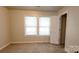 Well-lit bedroom featuring neutral walls, carpet floors, and two windows providing natural light at 12450 Stone Garden Dr, Huntersville, NC 28078