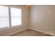 This bedroom includes carpeted floors and dual windows at 12450 Stone Garden Dr, Huntersville, NC 28078