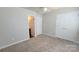 This bedroom includes carpeted floors, a closet, and access to the bathroom at 12450 Stone Garden Dr, Huntersville, NC 28078