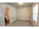 This bedroom has carpeted floors and access to the bathroom with a window at 12450 Stone Garden Dr, Huntersville, NC 28078